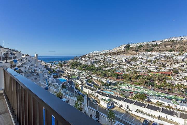 the tiered apartment blocks of Puerto Rico stacked up the ravine above the marina, Gran Canaria