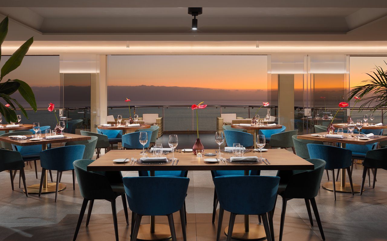the cliff-edge terrace at Restaurant Aqua inside the Royal Sun Resort